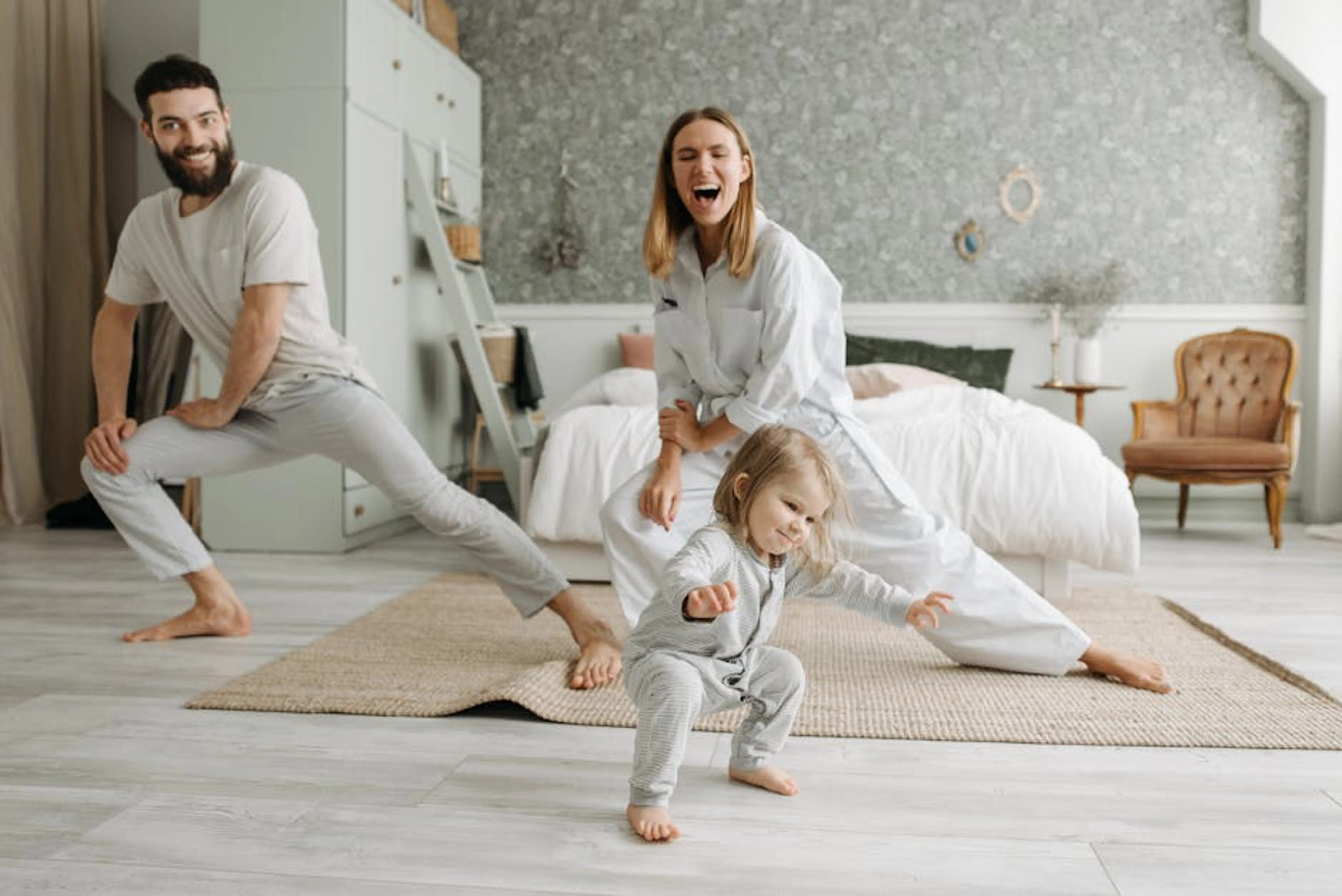 A joyful family engaging in morning stretches together, fostering a fun and healthy routine. A family calmly eating breakfast together, smiling and chatting, with a neatly organized kitchen