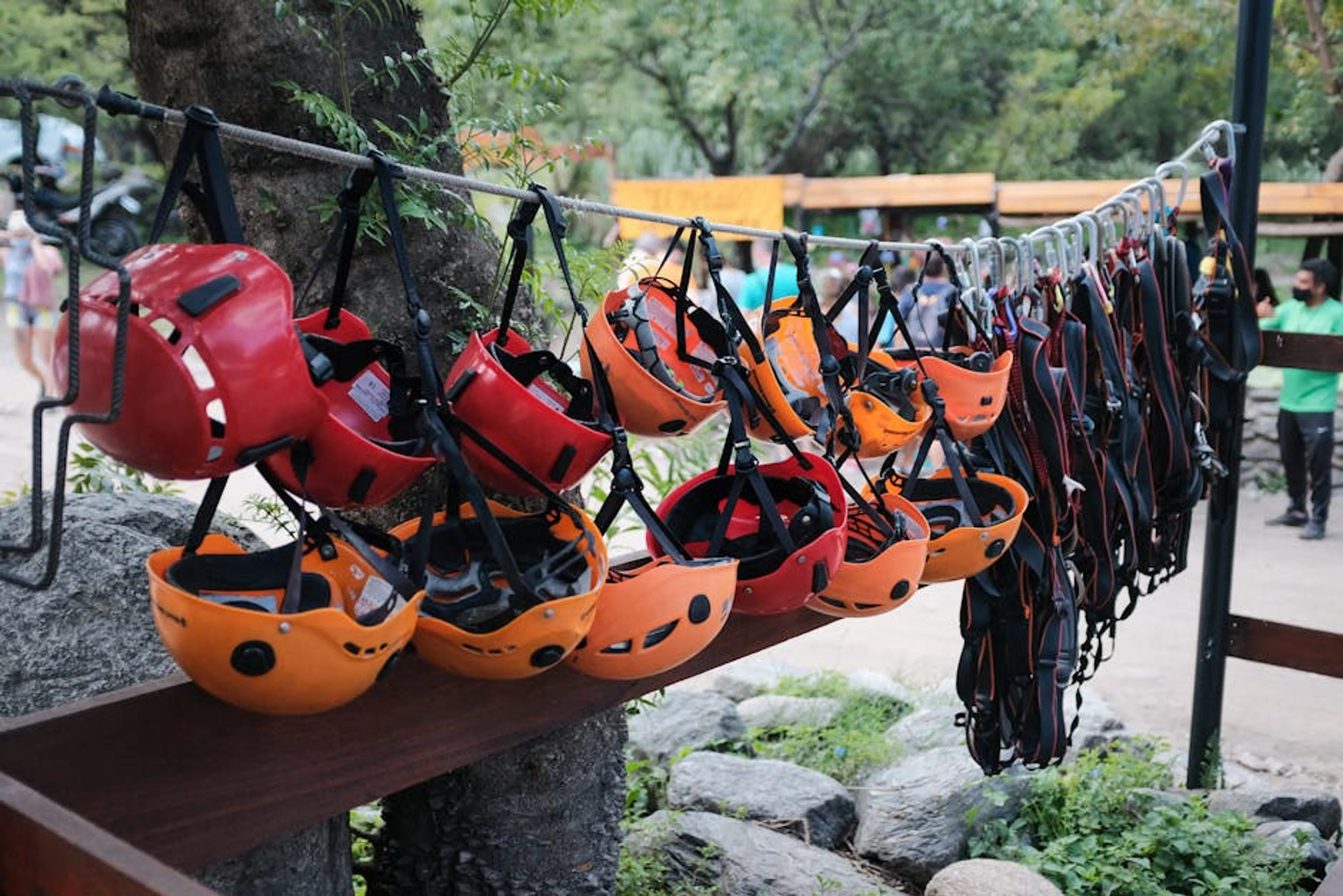 Hanging colorful helmets for climbing adventures in Merlo, Argentina. A collection of travel safety items including a personal alarm, power bank, and first-aid kit